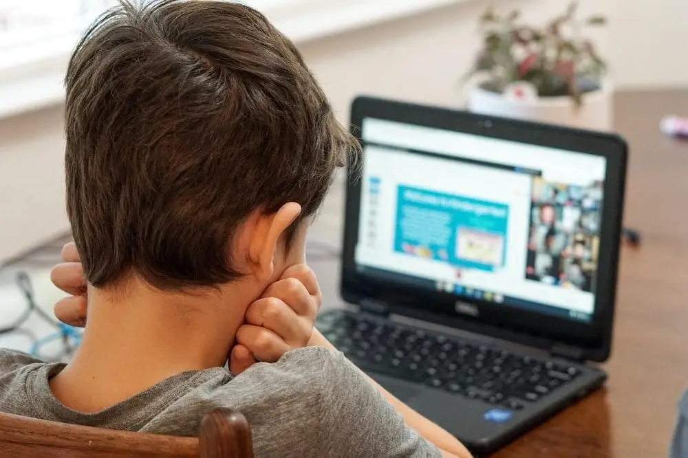 child learning from a laptop