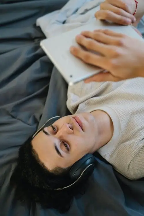 Person lying down watching a movie on iPad-min