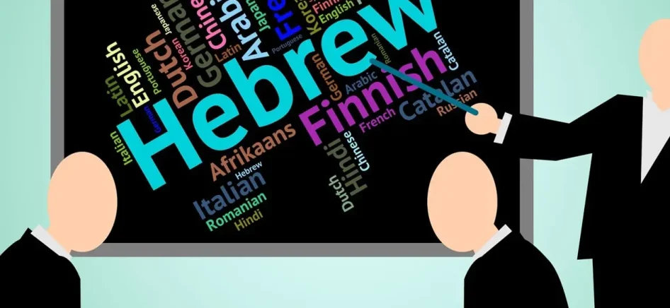 Man pointing to Hebrew on a blackboard