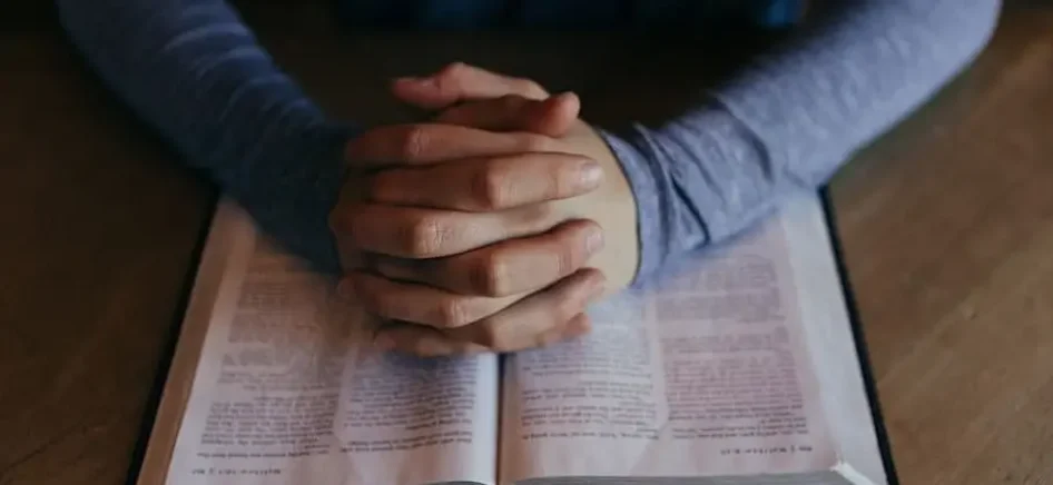 A person reading a book in Hebrew-min