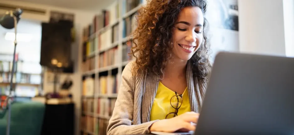 Beautiful brunette woman using notebook. Study, learning, university concept