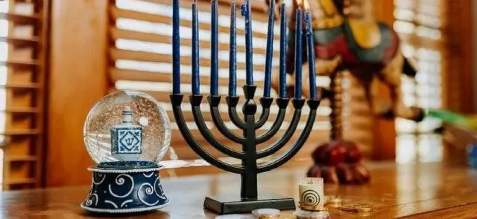Lit menorah candles on a table
