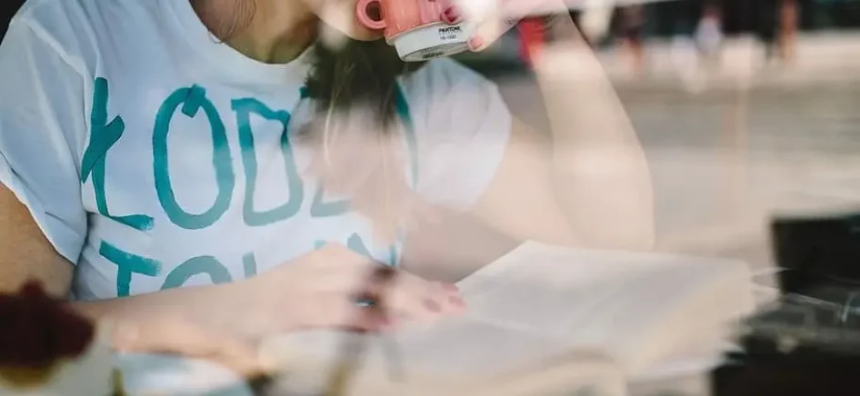Woman drinking coffee and reading