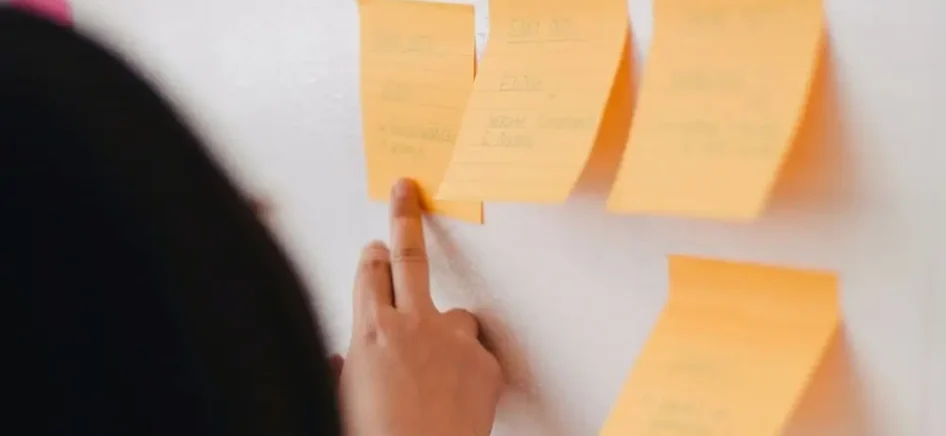 Woman reading from a post it