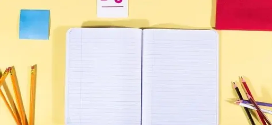 Open notebook with school accessories flat lay